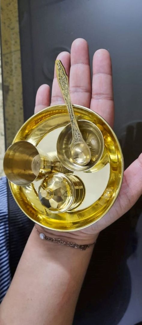 Top view of brass aarti thali with diya and kumkum holders, a classic brass thali for puja used in Hindu ceremonies and festive worship.