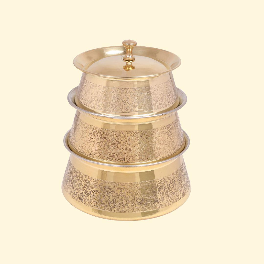 Set of 3 Brass Etching Design Brass Handi, Degchi, Patila (Pital ki handi, Pital ka Patila, Pital ke bartan) stacked vertically to demonstrate nesting. Each pot features a detailed floral etching pattern, with the smallest pot at the top secured by its matching lid.