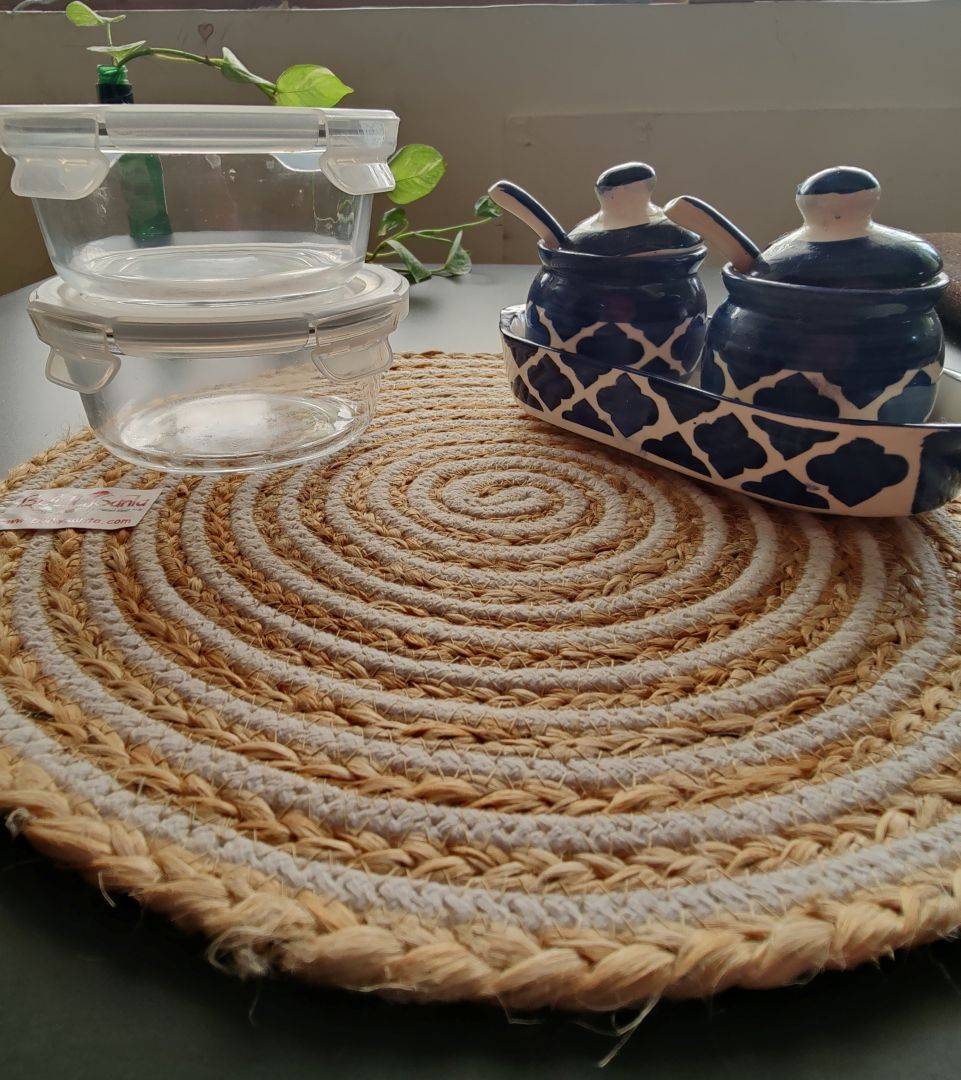 Handcrafted woven mat styled with cups and a bottle, perfect as round table
placemats.