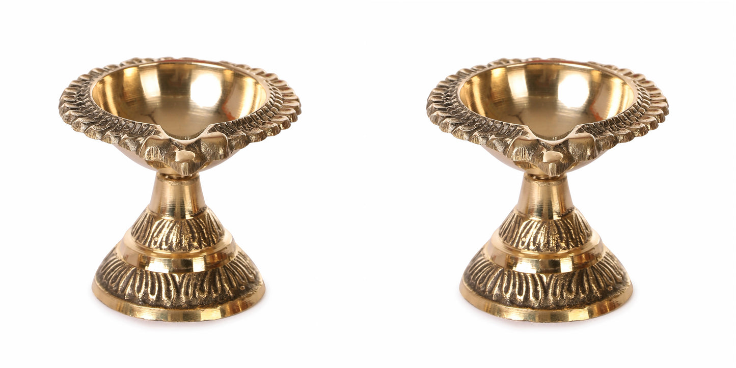 Two brass candle holders on a white background