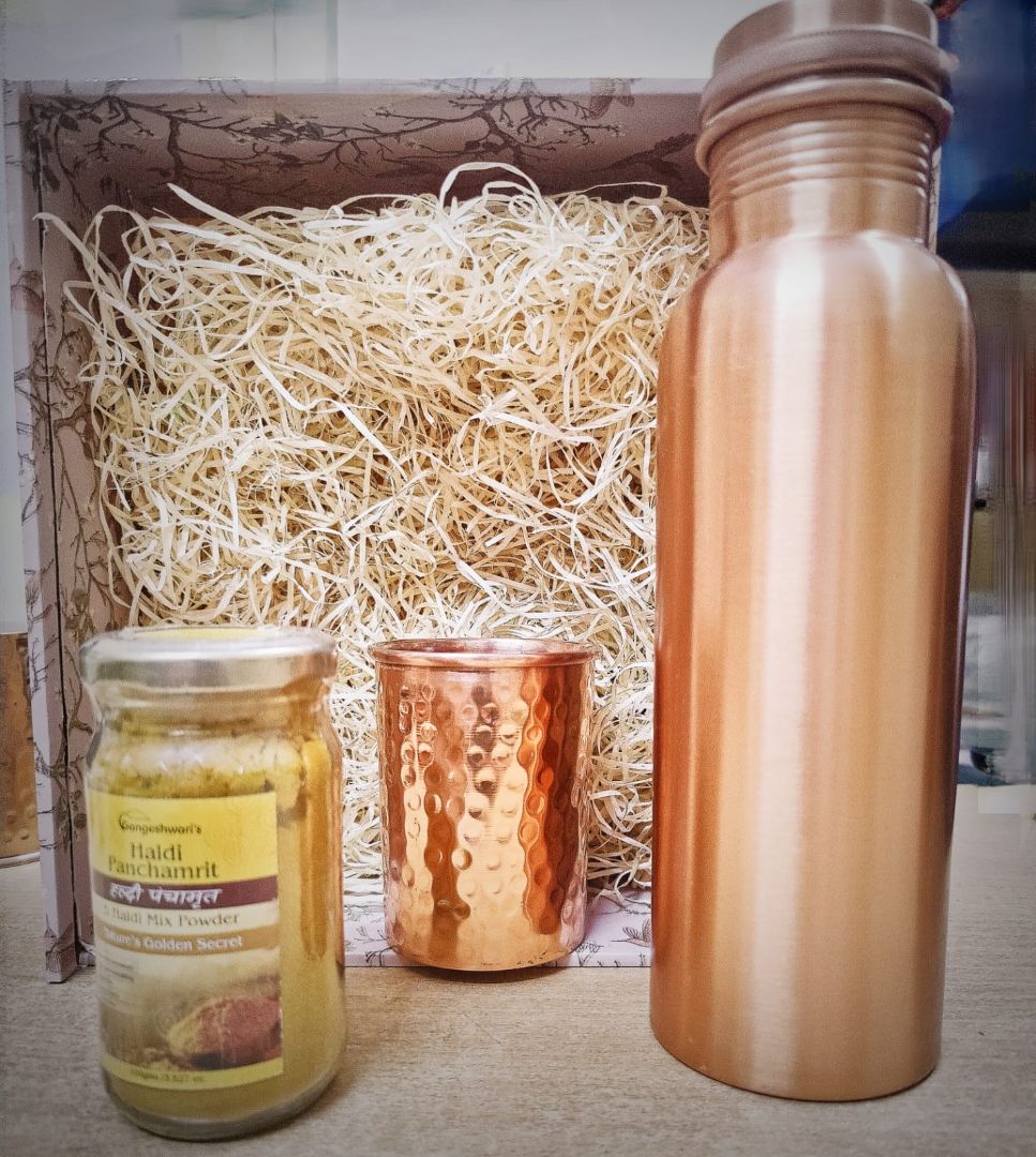 Premium copper wellness gift set featuring a copper bottle, hammered copper glass, and organic honey jar arranged in a handcrafted festive hamper box.