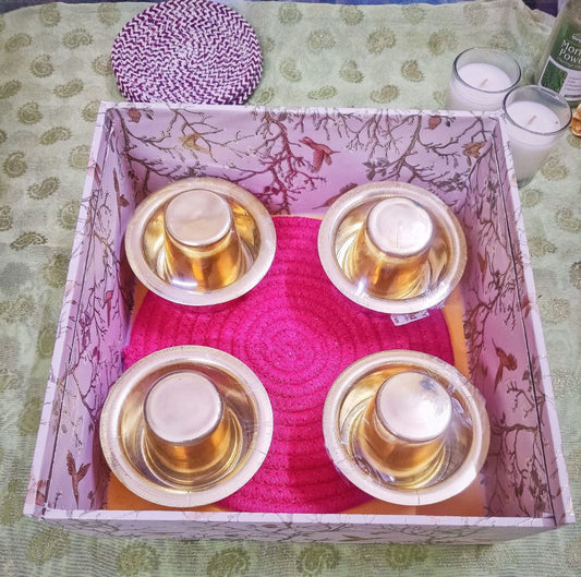 Elegant Golden Heritage Dabara Gift Set with polished brass dabara cups placed on a vibrant red base inside a patterned gift box for festive gifting.