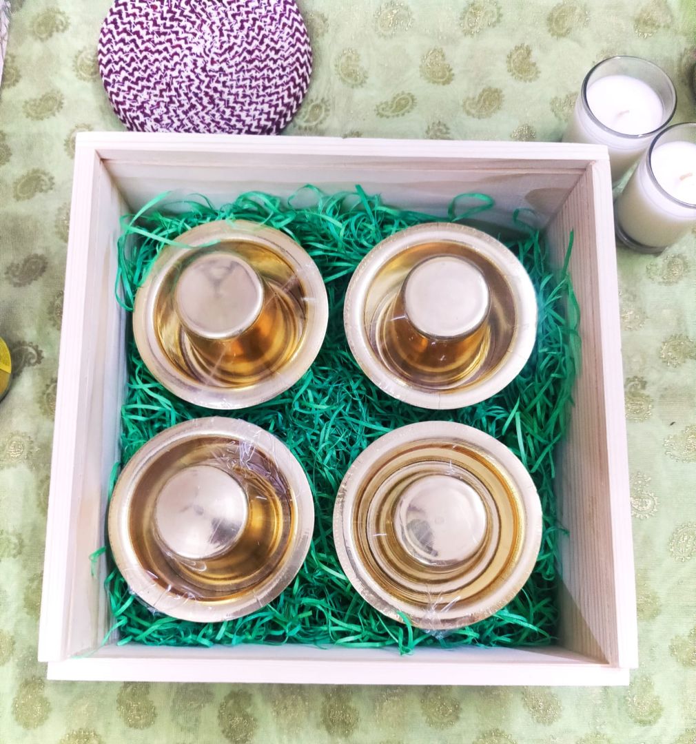 Brass dabara cups displayed in a Golden Heritage Dabara Gift Set box with a textured green base, offering a premium and traditional dabara gift set.