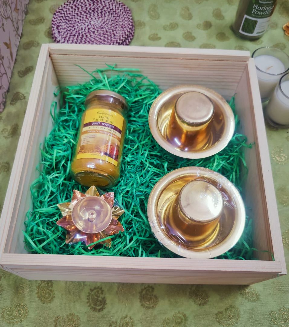 Dabara coffee set featuring a brass dabara filter, lotus-shaped diya, and honey jar styled together as a traditional handcrafted dabara coffee gift box.