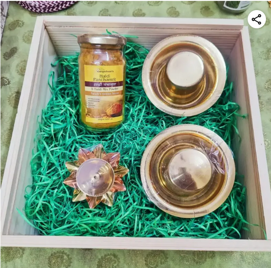 Brass dabara coffee set with lotus diya and honey jar arranged neatly on green
filler, creating an elegant handcrafted dabara coffee set gift presentation.