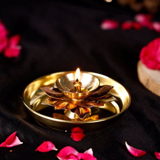 Lotus shaped diya placed on brass pooja thali, featuring a lotus flower diya design used for rituals and festive home temples.