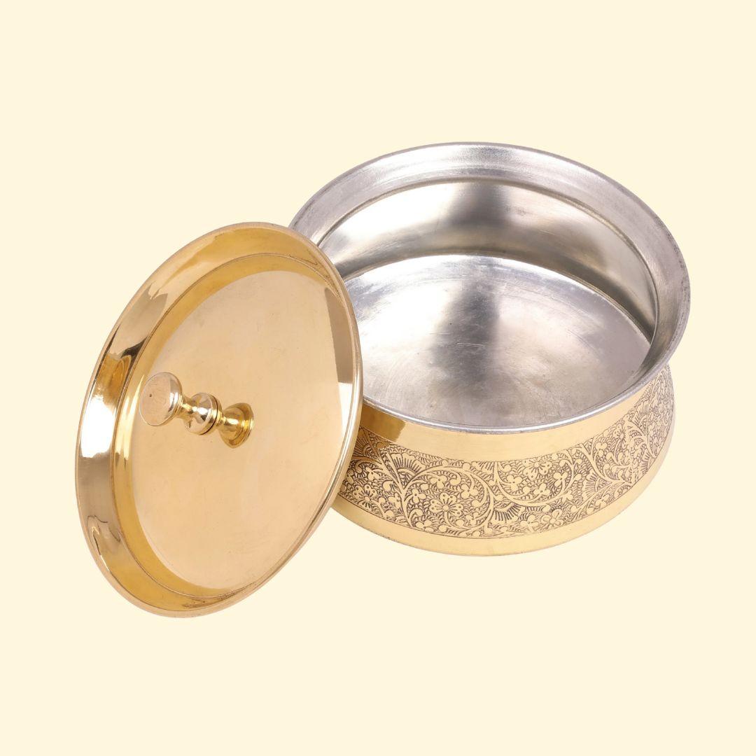 Brass handi for biryani with etched design used for traditional Indian serving