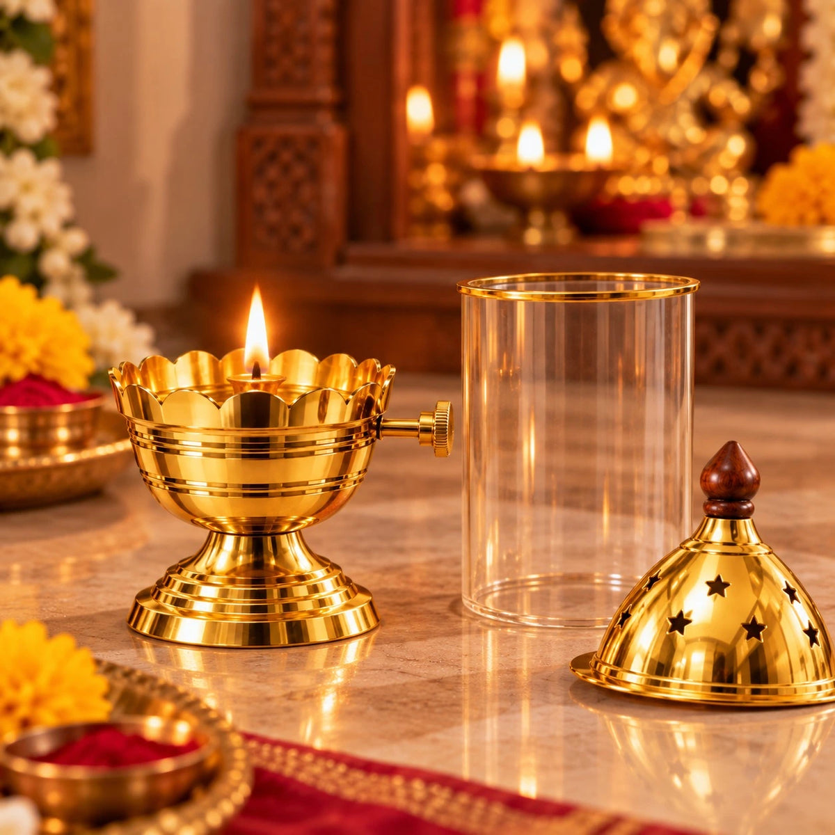 A brass oil lamp with a lit flame, a clear cylindrical glass or plastic cover, and a matching gold-toned lid with star cutouts, arranged on a marble surface in a warm, decorative setting with candles and flowers in the background. Brass Akhand Dia diya