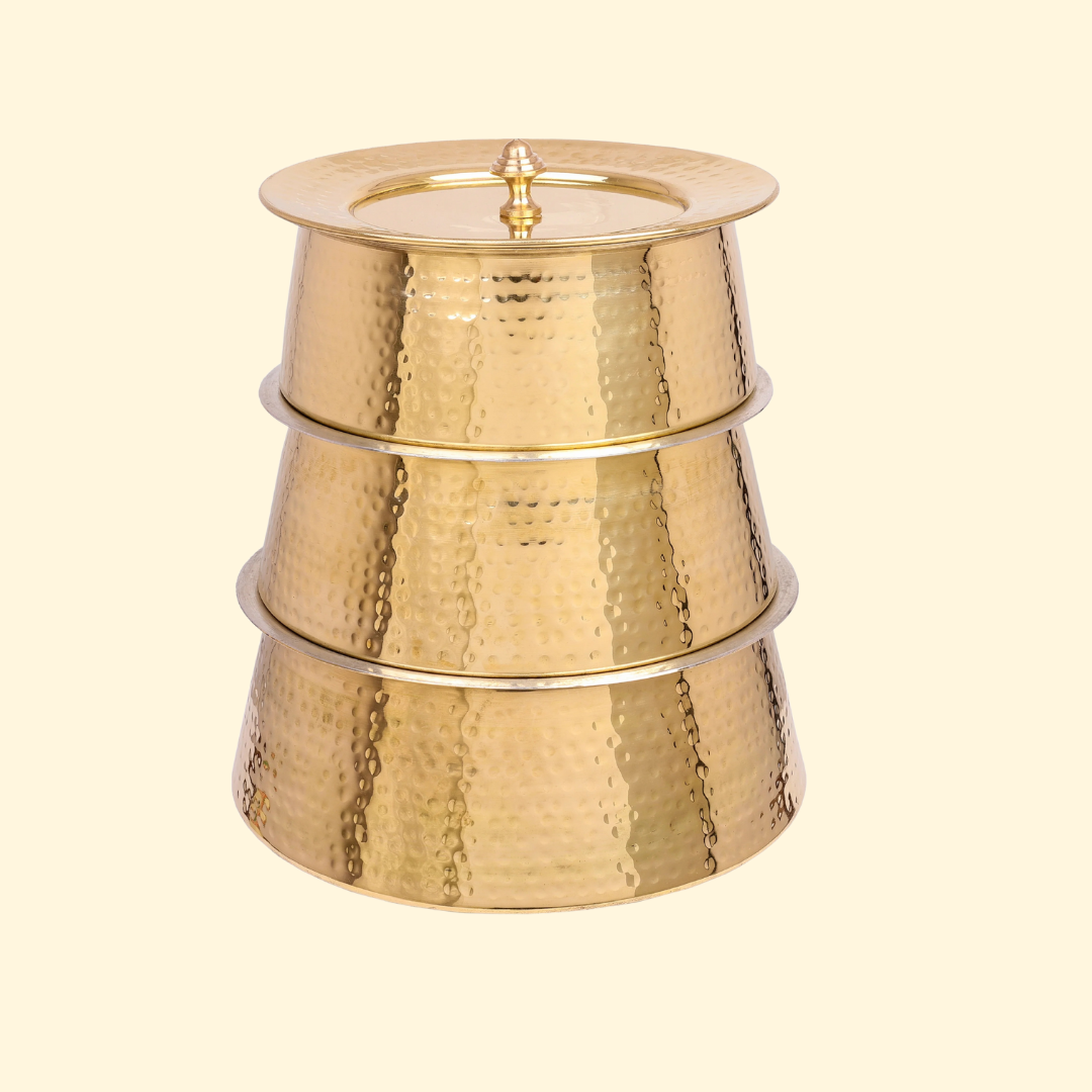 Set of three Bulkysanta Brass Handis (Hammered Brass Pots, Degchi, Patila) stacked vertically on top of each other to showcase their nesting ability and size difference. The three pots feature the distinctive hammered brass texture, with the top pot sealed by its matching lid.