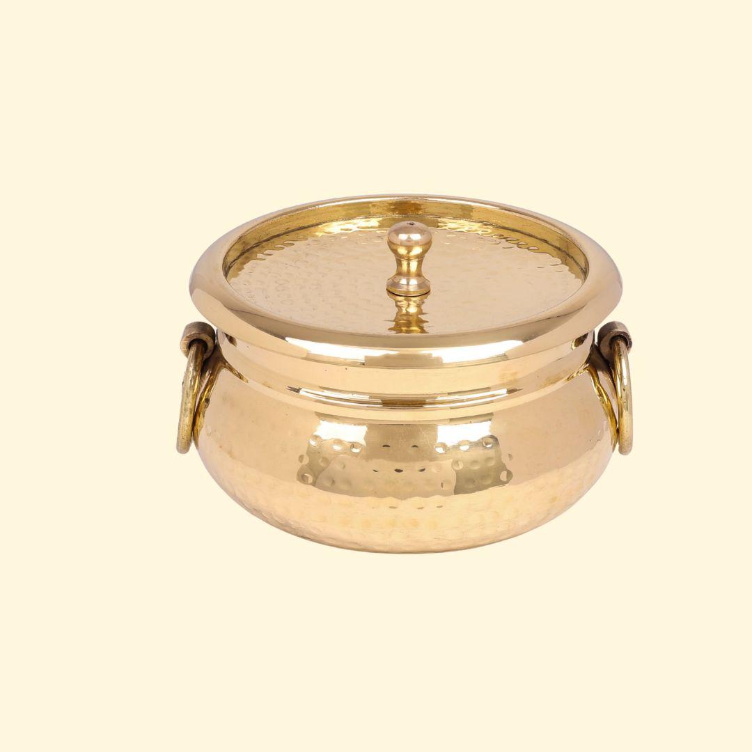 Classic Pot Style Brass Handi, Degchi, Patila (Pital ki handi, Pital ka Patila, Pital ke bartan) with its lid on and featuring two prominent brass ring handles on the sides. The pot has a traditional round shape and a shiny, hammered brass finish.