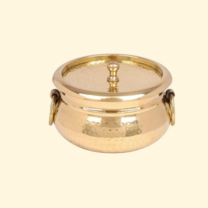 Classic Pot Style Brass Handi, Degchi, Patila (Pital ki handi, Pital ka Patila, Pital ke bartan) with its lid on and featuring two prominent brass ring handles on the sides. The pot has a traditional round shape and a shiny, hammered brass finish.