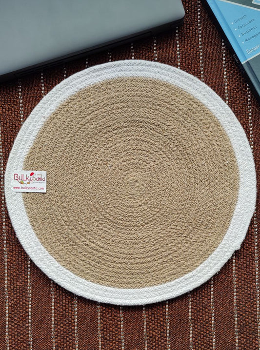 Beige and white woven round mat on a brown textured surface, showcasing
simple décor ideal for cotton placemats use.
