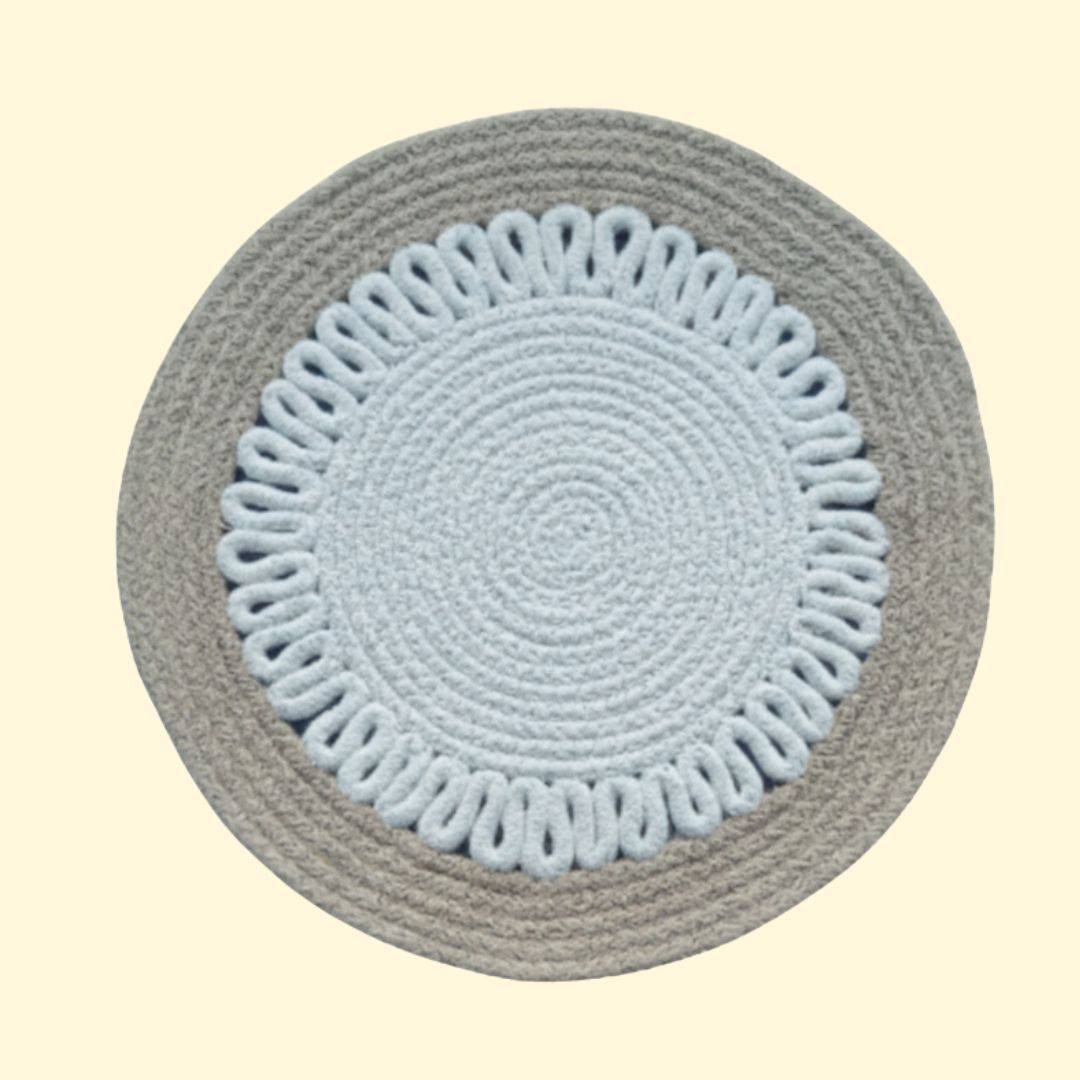 Detailed close-up of a beige and white patterned round mat on a clean tabletop,
perfect as round decorative placemats.