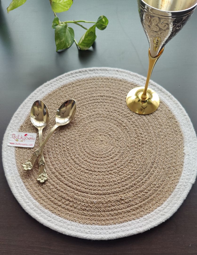 Textured round mat with brass wine glass and rustic décor placed on it, capturing a homely
dining mood for round placemats for dining table.