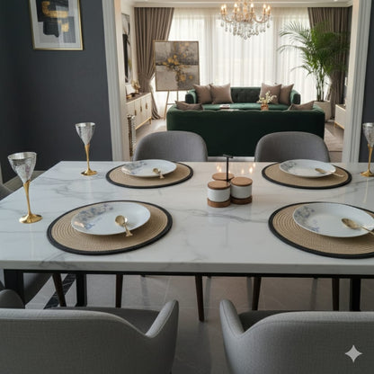 Dining table set with plates, glasses, and cutlery in a modern living room, along with Cotton Table Mats with Brass Wine glass