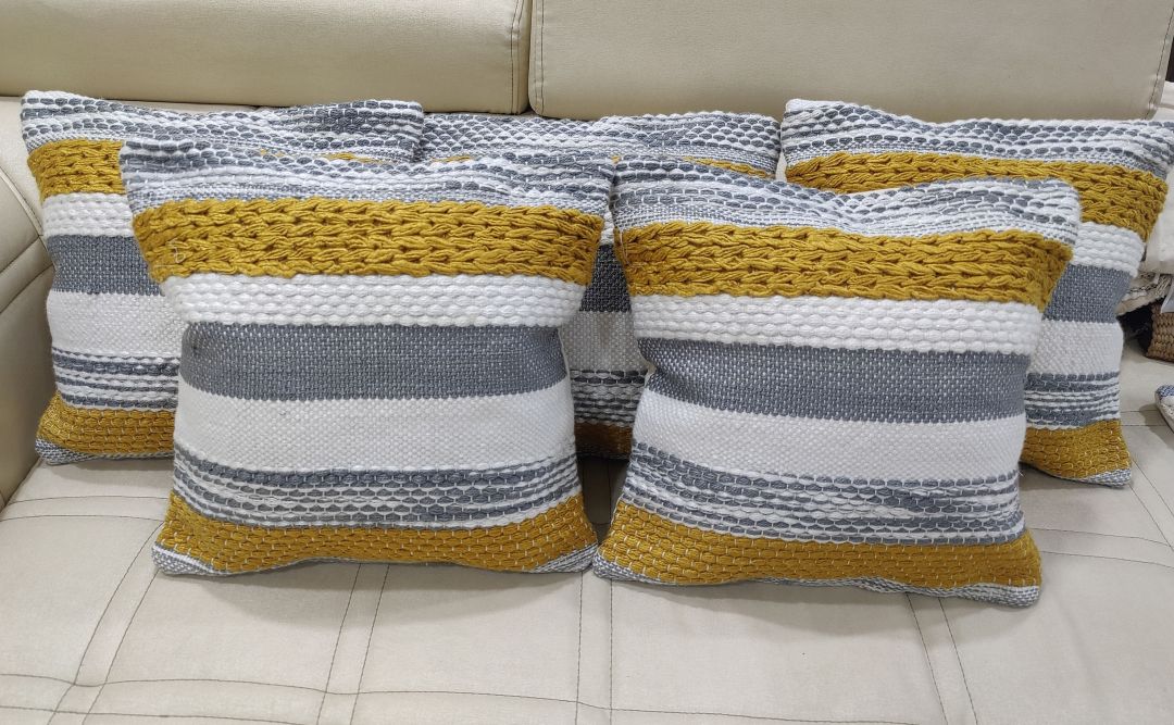 Set of three striped premium cotton cushion covers arranged in a row.