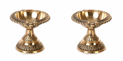 Two brass candle holders on a white background