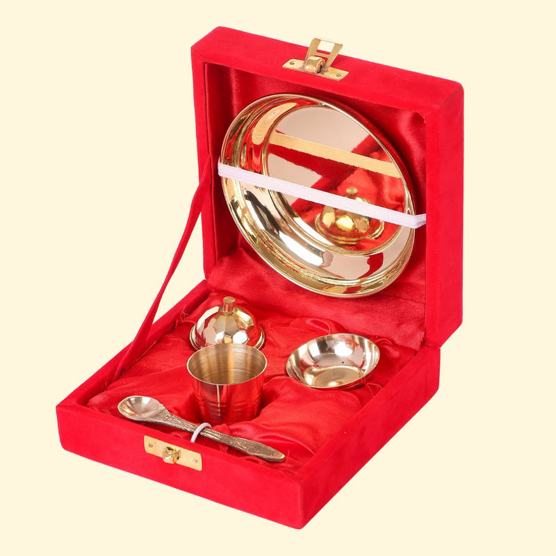Pure brass pooja thali arranged in a red velvet gift box with diya, bowls, spoon and plate, a traditional brass thali for puja and devotional rituals.