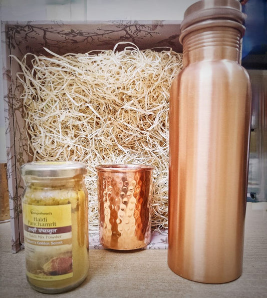Premium copper wellness gift set featuring a copper bottle, hammered copper glass, and organic honey jar arranged in a handcrafted festive hamper box.​