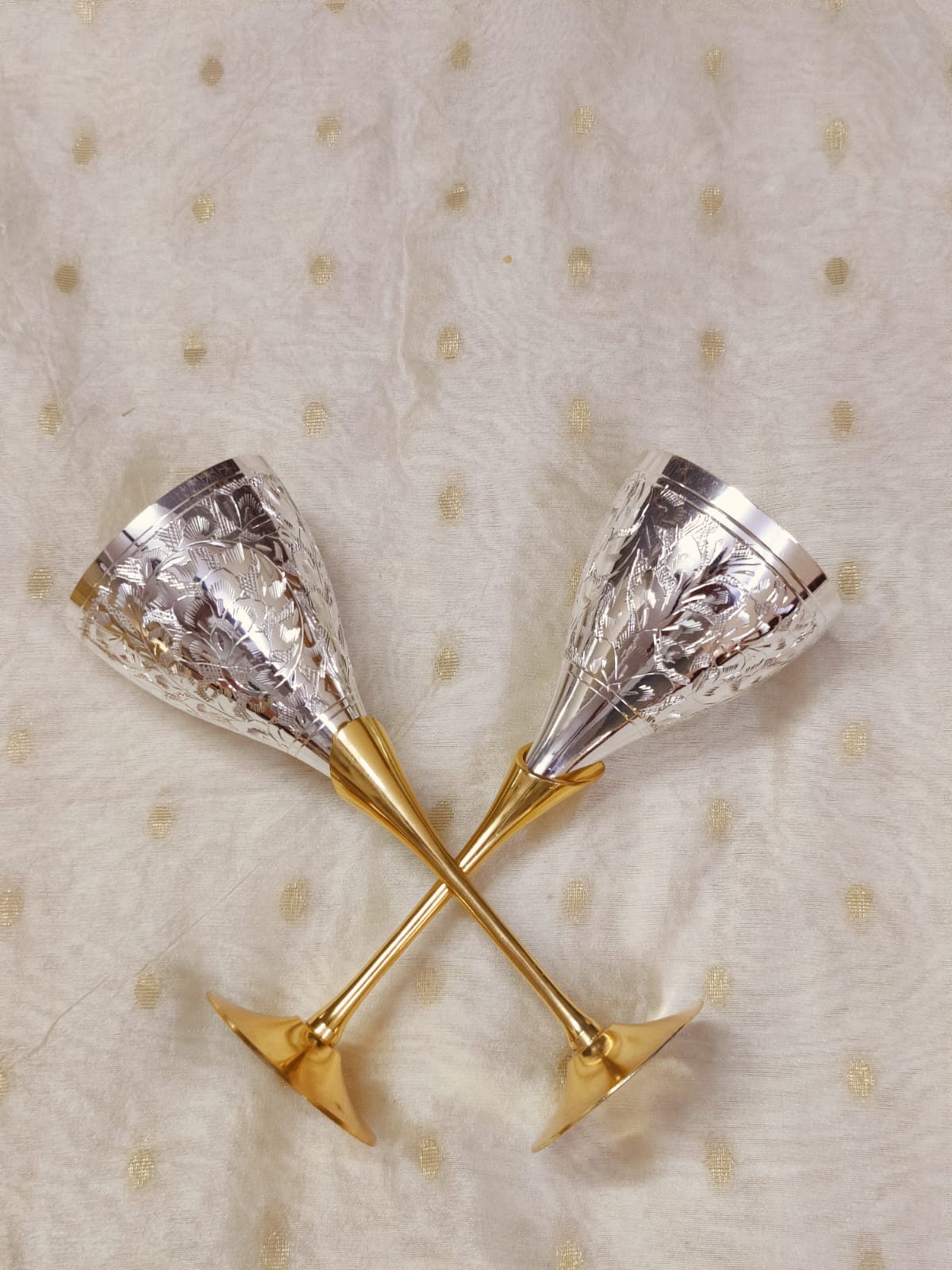 Vintage style champagne flute with engraved silver exterior and brass stem.