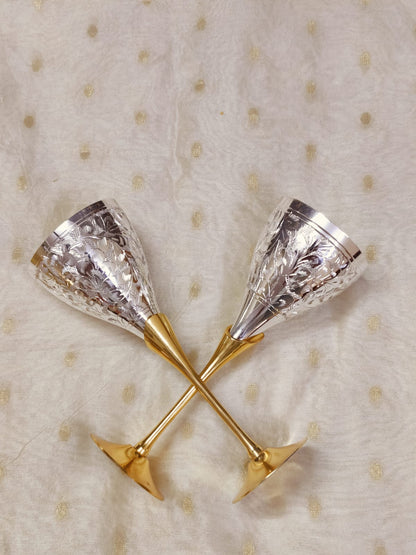 Vintage style champagne flute with engraved silver exterior and brass stem.