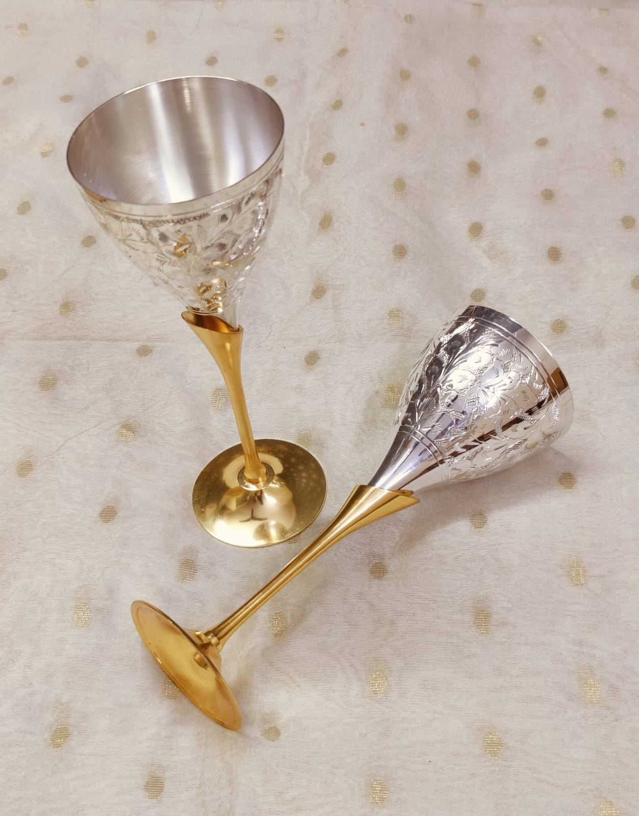 Traditional metal wine glasses in silver and brass, handcrafted engraved design.