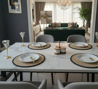 Complete round table mats dining set arranged on a table with cotton placemats,
coasters and organizer basket in beige and black.