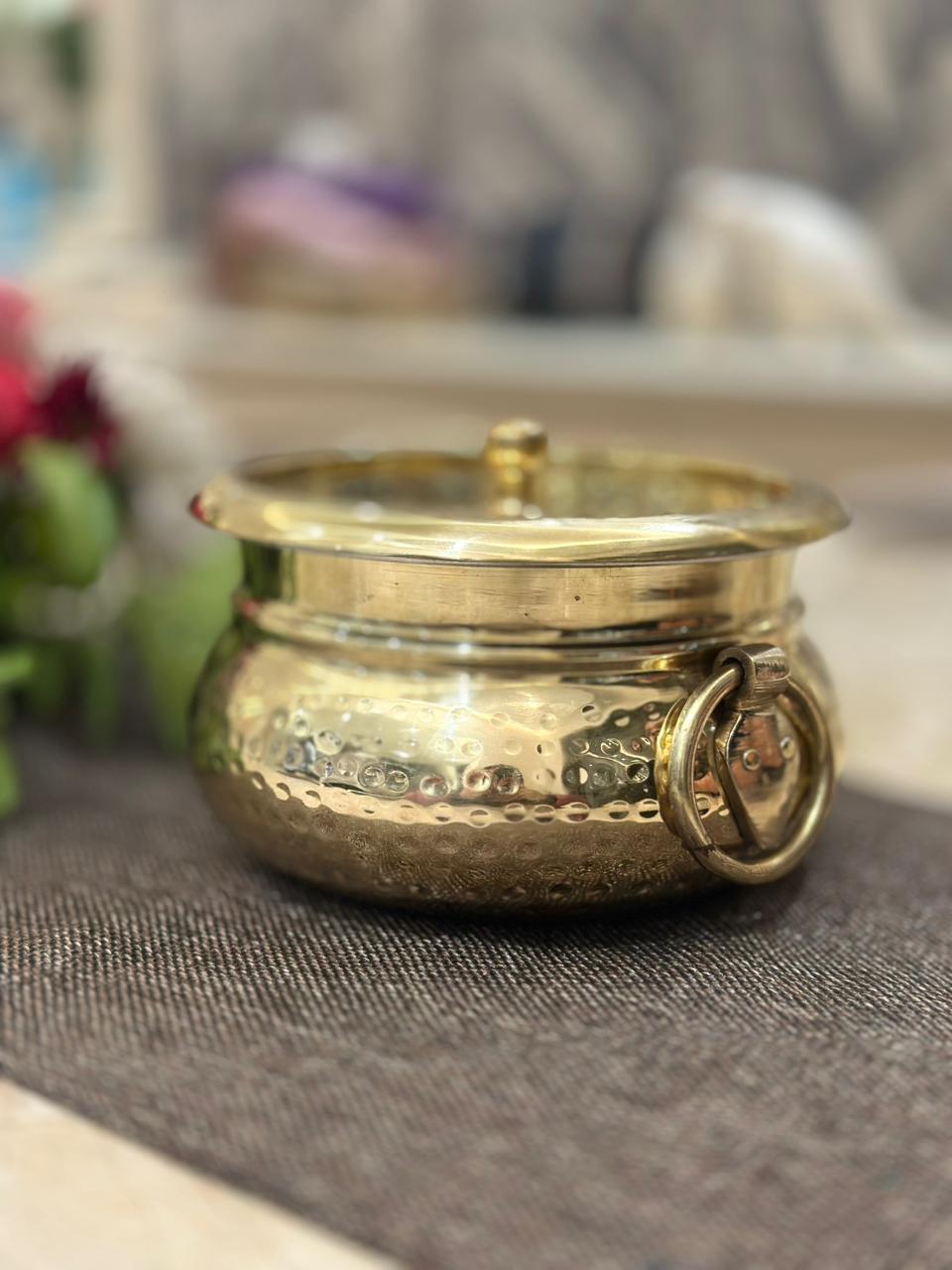 brass container with lid on a textured surface