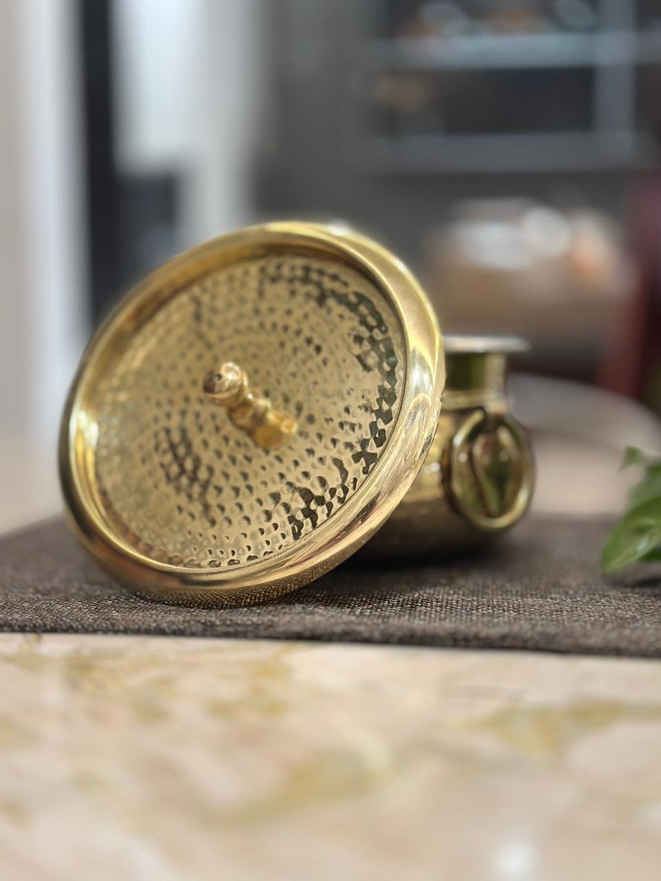 Gold decorative item on a surface with a blurred background