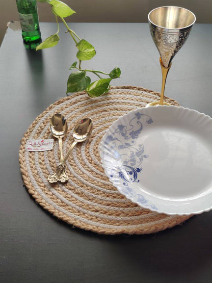 Natural woven spiral mat holding table décor pieces, suitable as washable round
placemats.