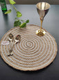 Braided spiral mat displayed with cutlery and décor on a dining setup, used as
neutral round placemats.