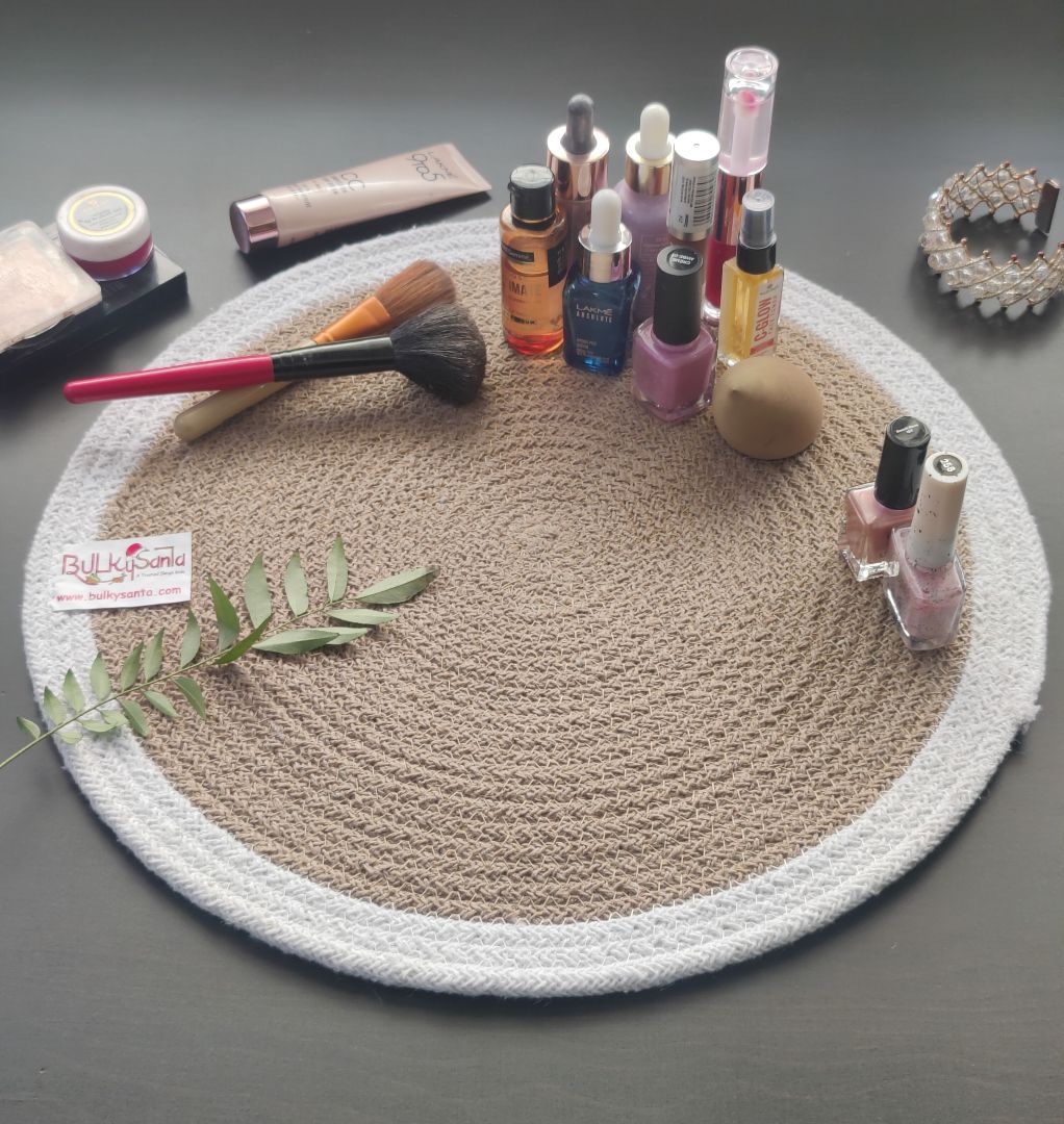 Round woven mat with pen and small accessories on a brown table, highlighting
stylish round table mats.
