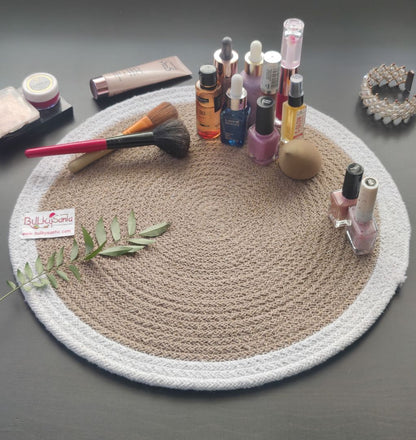Round woven mat with pen and small accessories on a brown table, highlighting
stylish round table mats.