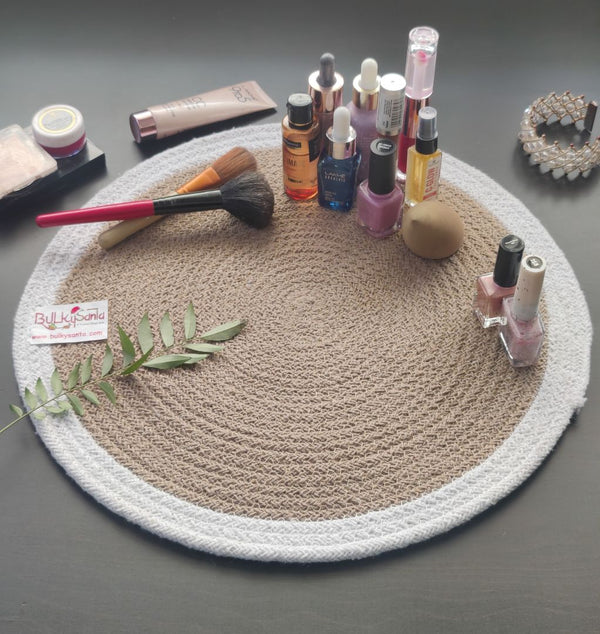 Round woven mat with pen and small accessories on a brown table, highlighting
stylish round table mats.