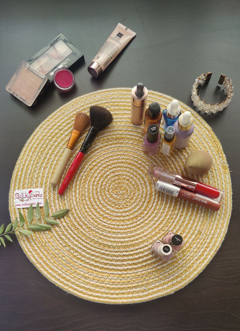 Yellow spiral-patterned mat arranged with golden décor items for a warm tabletop look using round placemats.