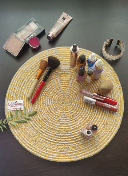 Yellow spiral-patterned mat arranged with golden décor items for a warm tabletop look using round placemats.