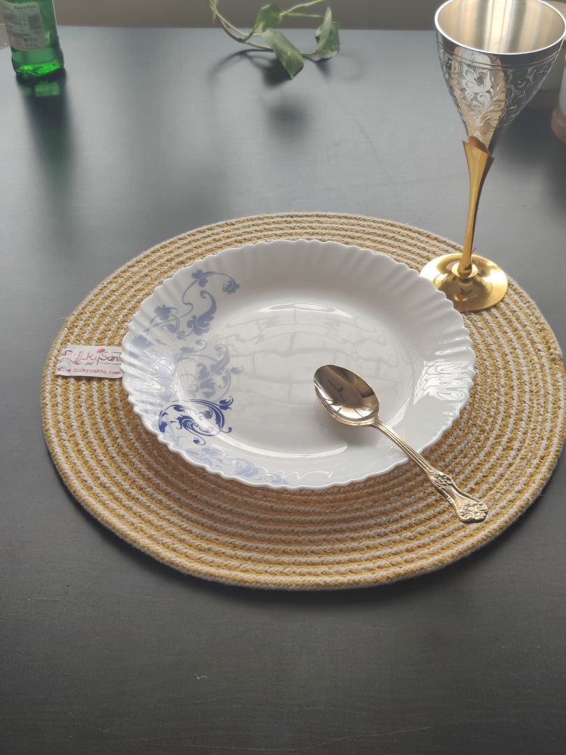 Close-up of a yellow and white woven mat on a clean table setting, adding charm as round cotton placemats.