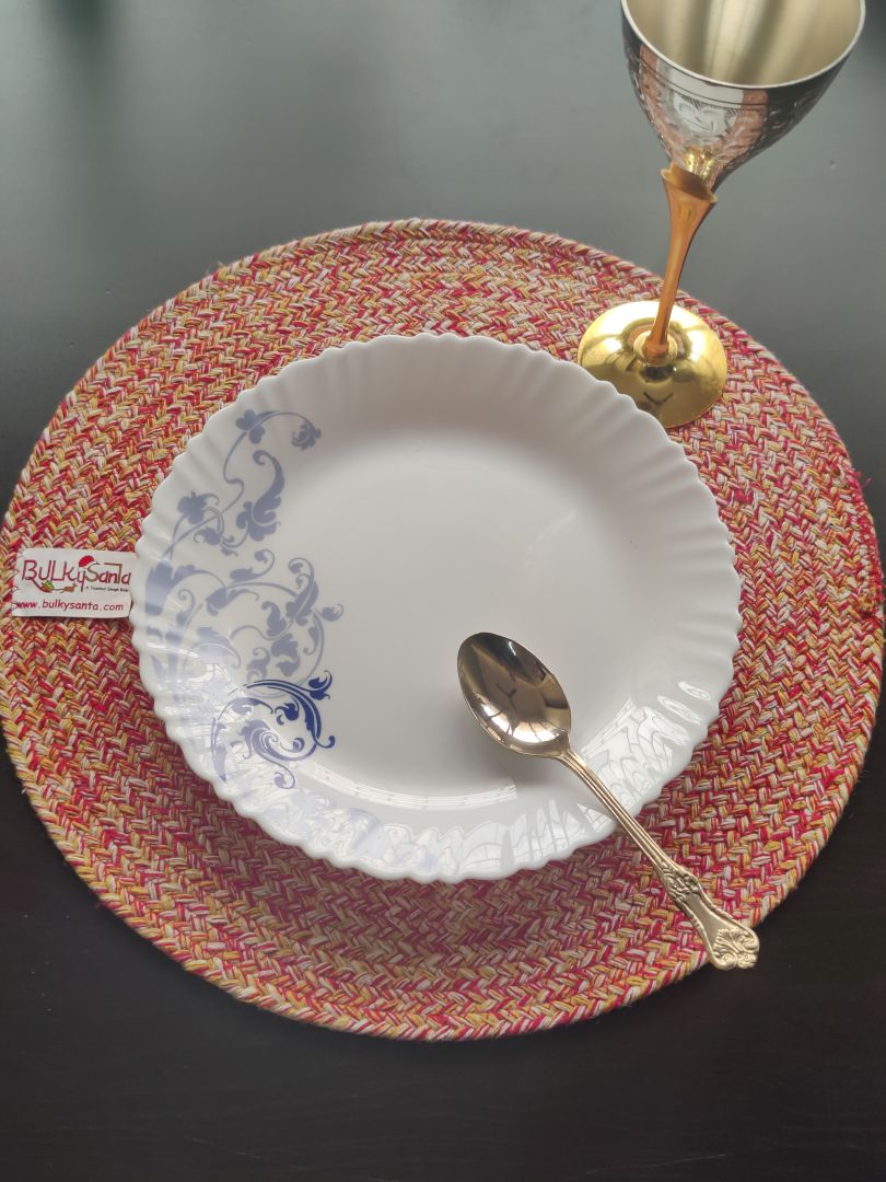 Round cotton mat arranged under green décor pieces, showcasing its vibrant braided pattern. VERSATILE BEIGE: Enhance your table with this warm, sandy beige table mat round. It's a timeless neutral, lighter than tan yet richer than cream, bringing a calm, inviting feel to your home.